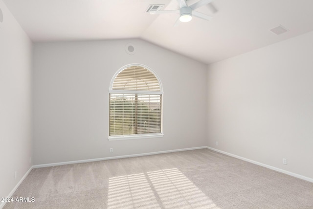 carpeted spare room with vaulted ceiling and ceiling fan