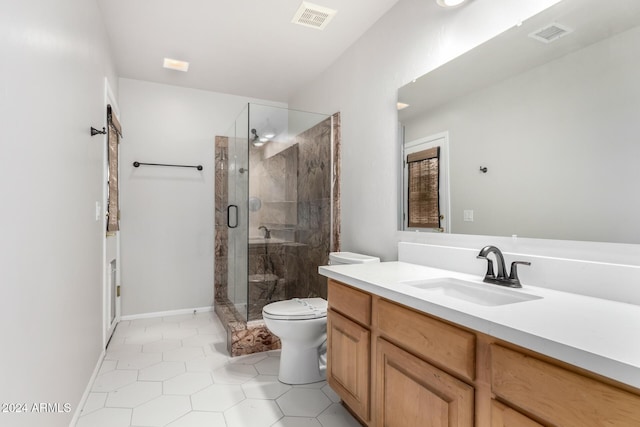 bathroom featuring tile patterned floors, a shower with door, vanity, and toilet