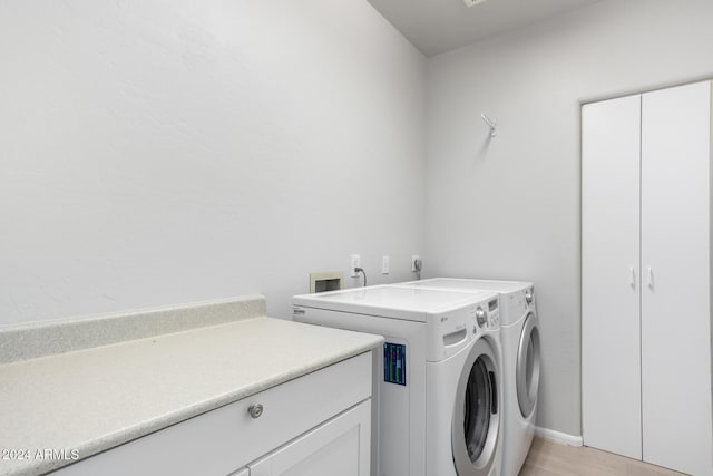 laundry area featuring cabinets and separate washer and dryer