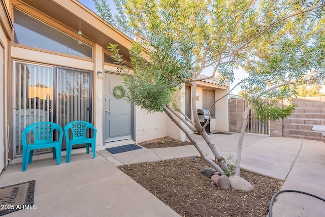 entrance to property featuring a patio