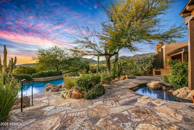 pool at dusk with a mountain view