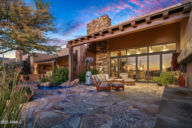 patio terrace at dusk with an outdoor hangout area