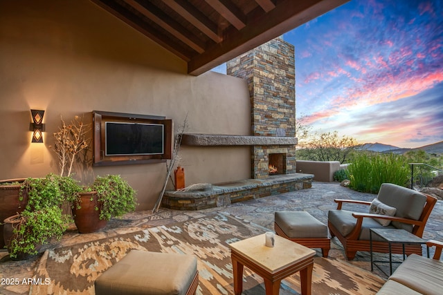 view of patio / terrace with an outdoor stone fireplace