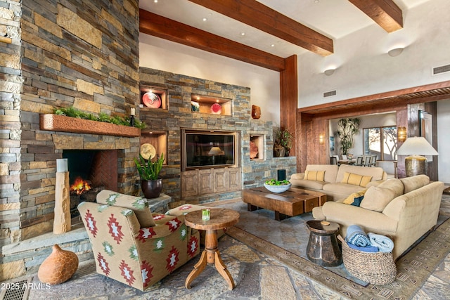 living room with beam ceiling and a stone fireplace