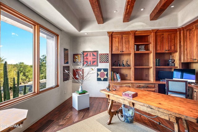 office featuring dark hardwood / wood-style floors, a healthy amount of sunlight, built in desk, and beam ceiling