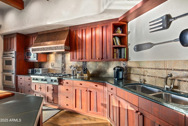 kitchen with premium range hood, sink, decorative backsplash, wood-type flooring, and stainless steel appliances