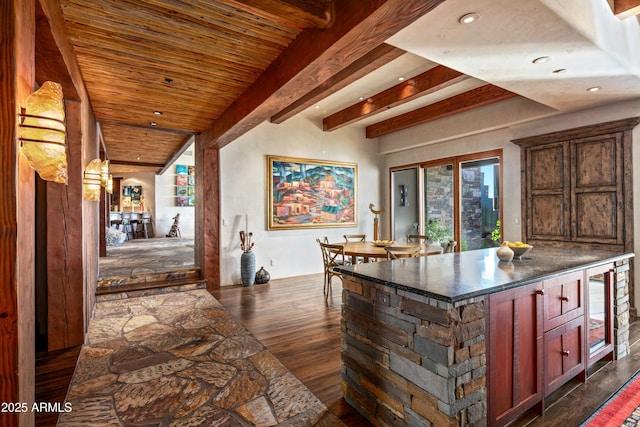 bar featuring beamed ceiling and dark hardwood / wood-style floors