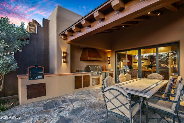 patio terrace at dusk with area for grilling and grilling area