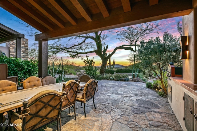 patio terrace at dusk featuring an outdoor bar