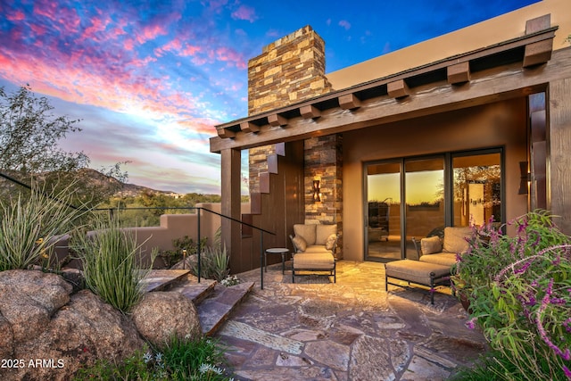 view of patio terrace at dusk