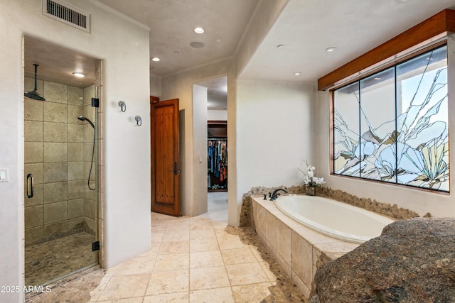 bathroom with separate shower and tub and plenty of natural light