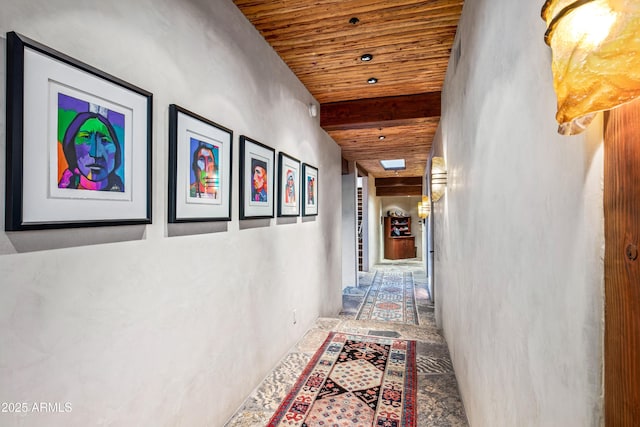 hall featuring beamed ceiling and wooden ceiling