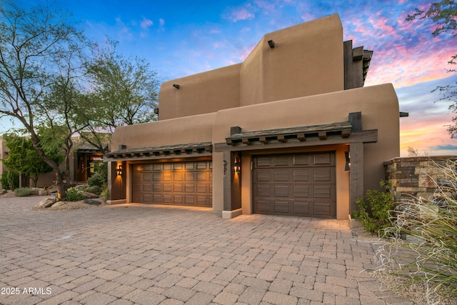 adobe home featuring a garage