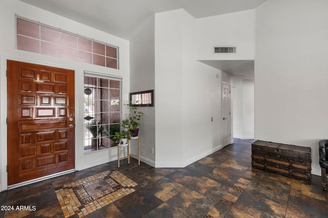 entryway featuring a towering ceiling