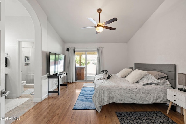 bedroom featuring ceiling fan, access to exterior, ensuite bathroom, light hardwood / wood-style floors, and vaulted ceiling