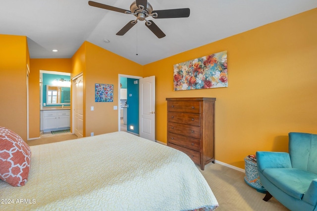 bedroom with connected bathroom, light colored carpet, vaulted ceiling, and ceiling fan