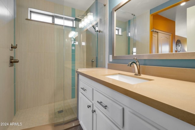 bathroom featuring vanity and an enclosed shower