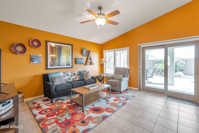 tiled living room featuring ceiling fan and vaulted ceiling