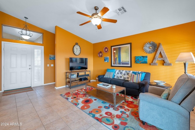 living room featuring ceiling fan, lofted ceiling, and light tile patterned floors