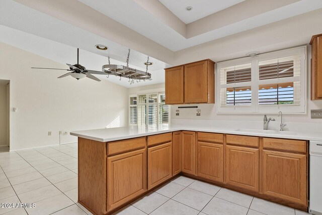 kitchen featuring ceiling fan, sink, kitchen peninsula, white dishwasher, and light tile patterned floors