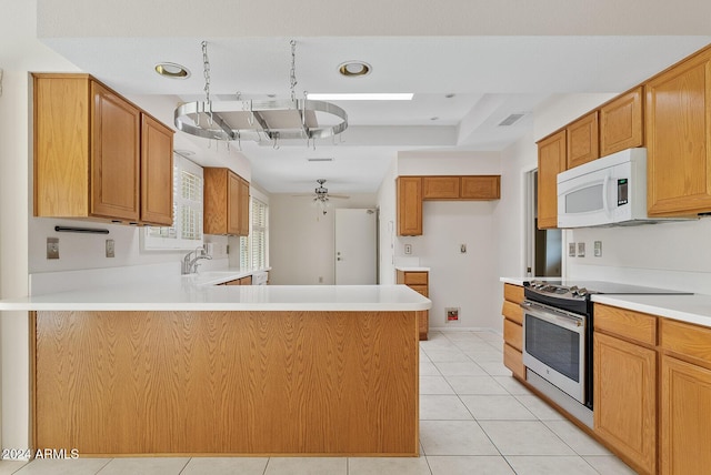 kitchen with kitchen peninsula, light tile patterned floors, ceiling fan, and stainless steel range oven