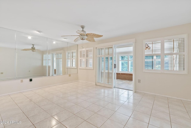 spare room featuring ceiling fan and light tile patterned flooring