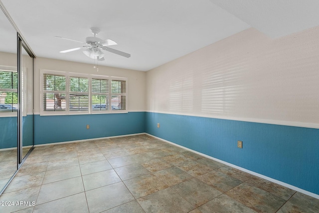 unfurnished room with ceiling fan