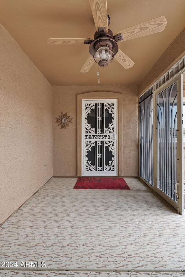 property entrance featuring ceiling fan