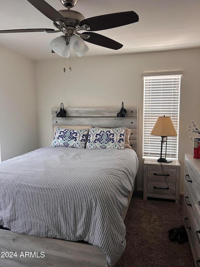 bedroom with dark carpet and ceiling fan