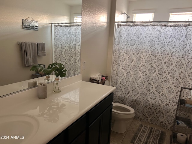 bathroom featuring vanity, a shower with curtain, toilet, and tile patterned flooring