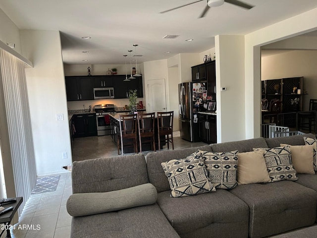 tiled living room featuring ceiling fan