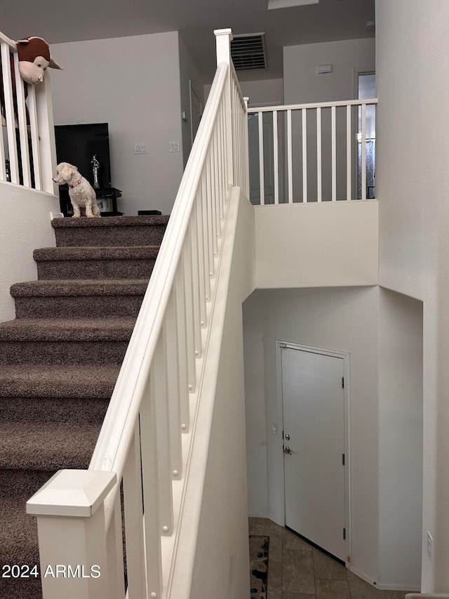 stairway with tile patterned floors