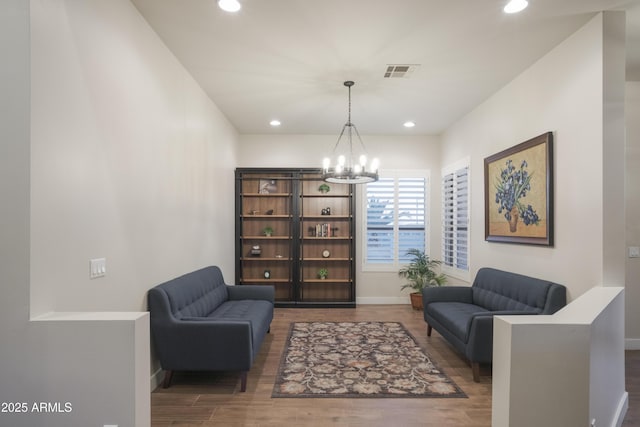 living area with a chandelier and dark hardwood / wood-style floors