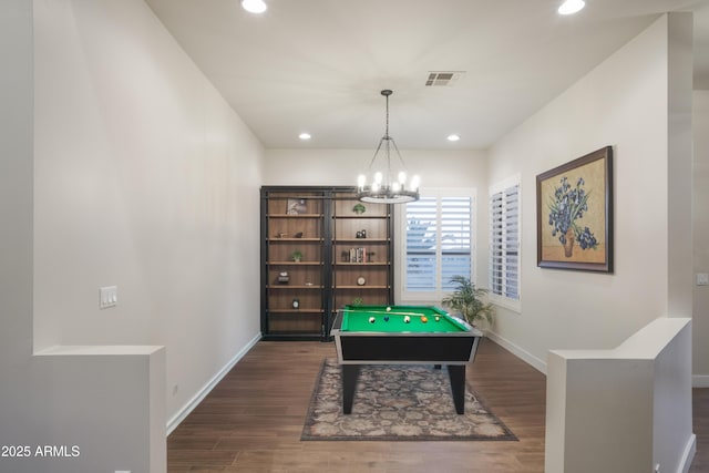 playroom with dark hardwood / wood-style flooring and a notable chandelier