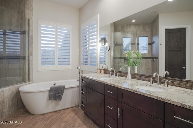 bathroom featuring vanity and separate shower and tub