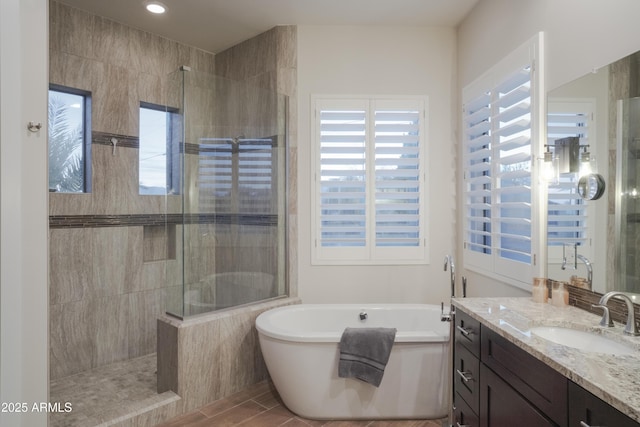 bathroom featuring vanity and shower with separate bathtub