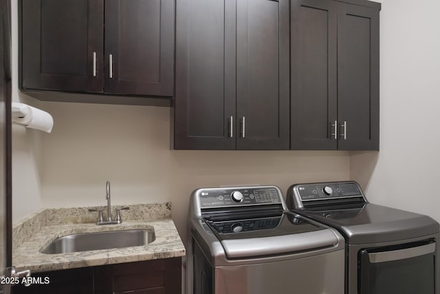 clothes washing area with sink, cabinets, and independent washer and dryer