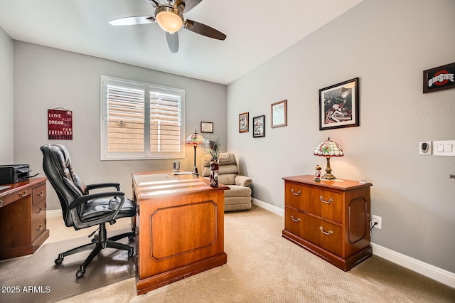 office area with baseboards, a ceiling fan, and light colored carpet