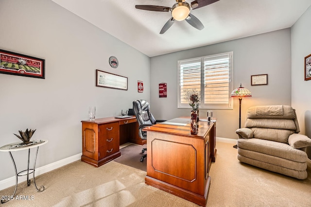 home office with baseboards, a ceiling fan, and light colored carpet