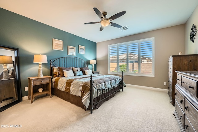 bedroom featuring baseboards, a ceiling fan, visible vents, and light colored carpet