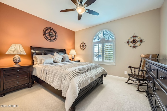 bedroom featuring light carpet, ceiling fan, baseboards, and vaulted ceiling