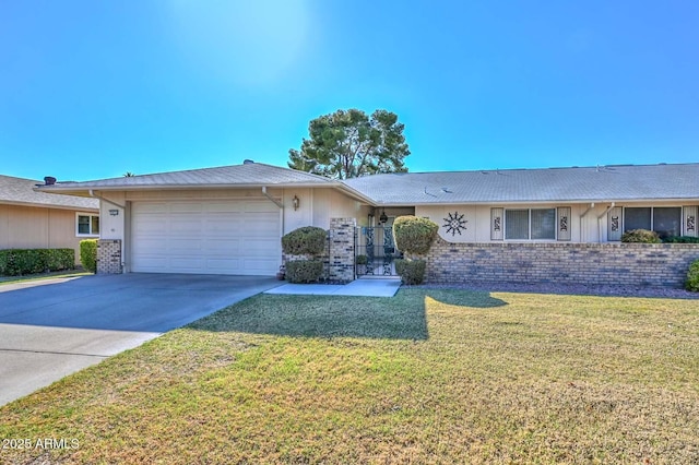 ranch-style home featuring a front lawn, concrete driveway, brick siding, and an attached garage