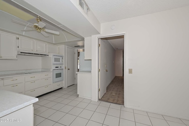 kitchen featuring white cabinets, white appliances, visible vents, and light countertops