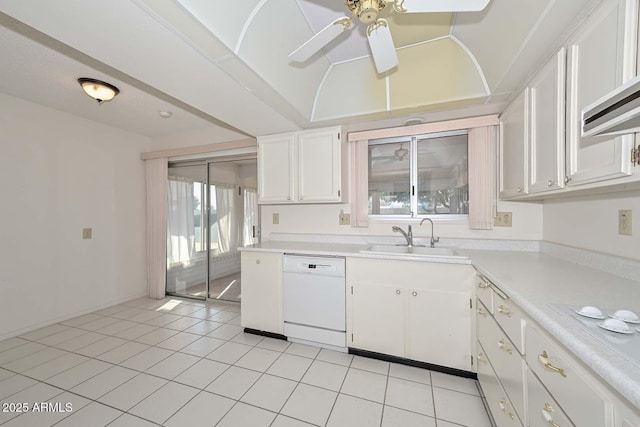 kitchen featuring white appliances, light countertops, a sink, and white cabinetry