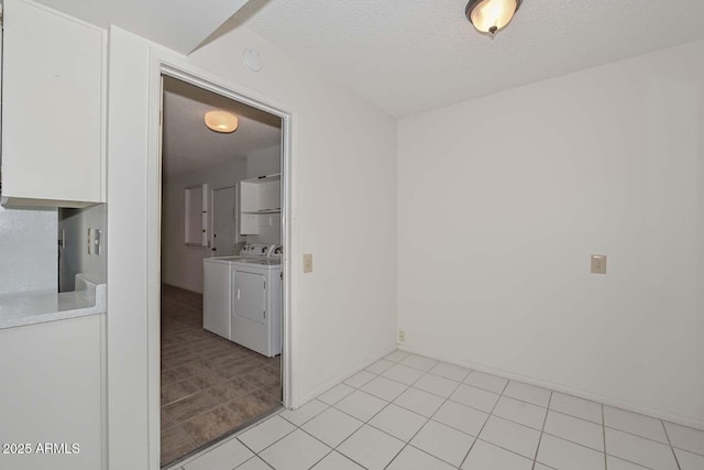 interior space featuring independent washer and dryer and a textured ceiling