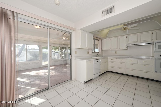 kitchen featuring light countertops, visible vents, white cabinetry, a sink, and white appliances