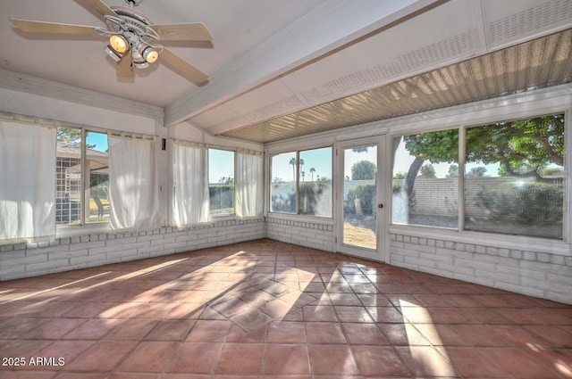 unfurnished sunroom with beamed ceiling and a ceiling fan