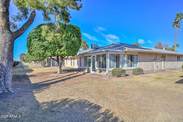 back of property with a sunroom