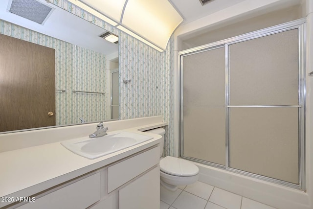 bathroom with wallpapered walls, toilet, tile patterned floors, an enclosed shower, and vanity