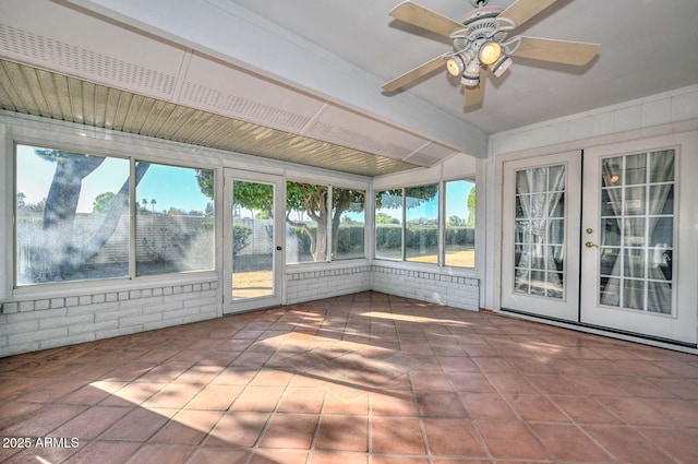 unfurnished sunroom with ceiling fan and beamed ceiling